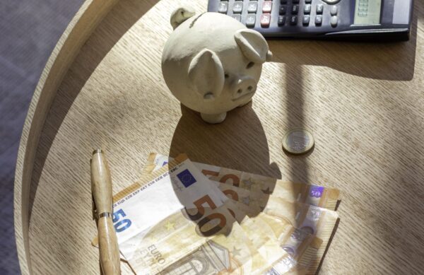 vertical-view-from-cash-money-wad-bills-coins-calculator-invesment-concept-ho (1) (1)